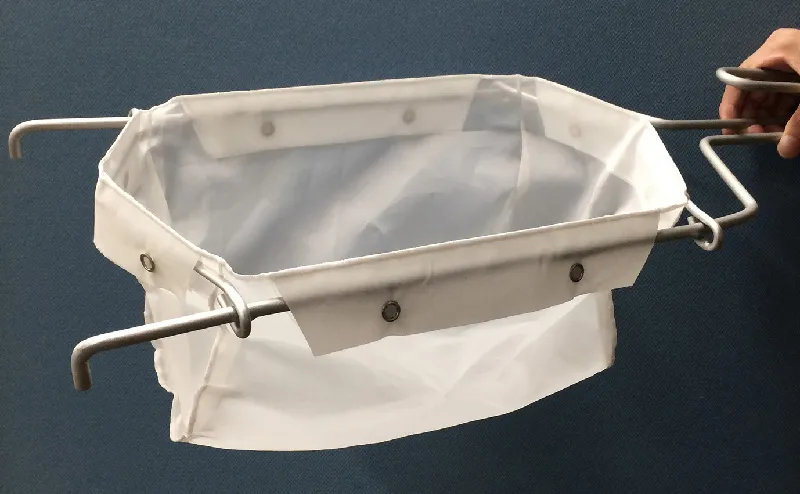 Photo of fryer mesh with a white mesh cloth bag attached to the metal frame