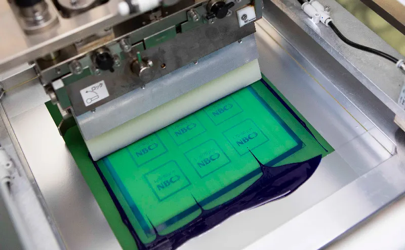 Screen printing machine in operation